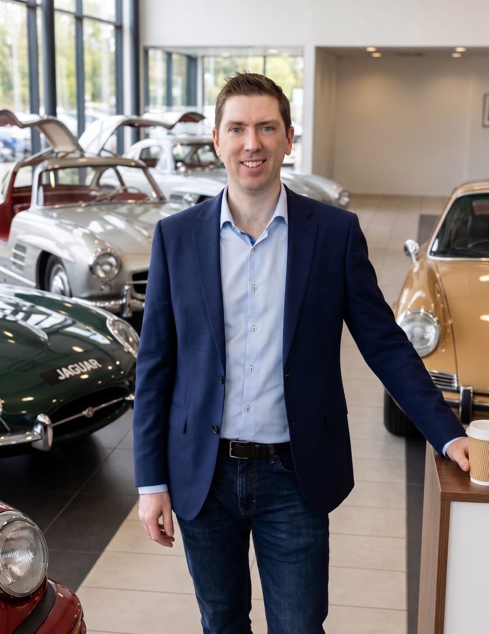 Glenn Harwood in a classic car showroom
